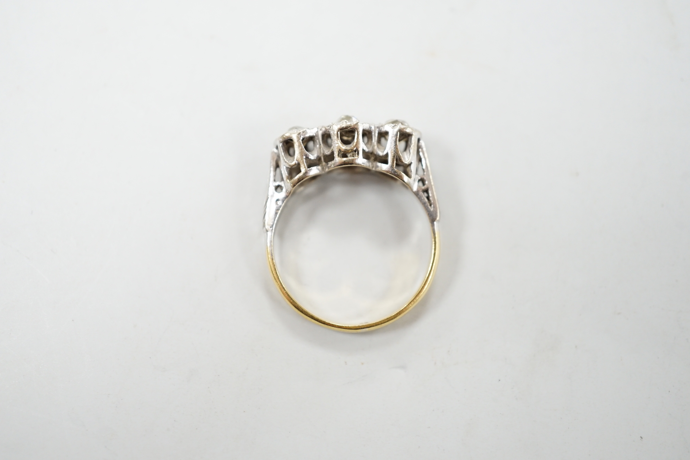 A yellow metal and illusion set three stone diamond ring, size M, gross weight 4.1 grams.